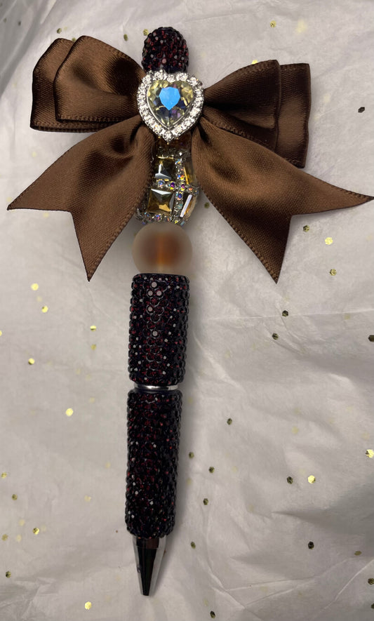 Brown Pen with a Brown Bow and Silver-ish Heart at the Top